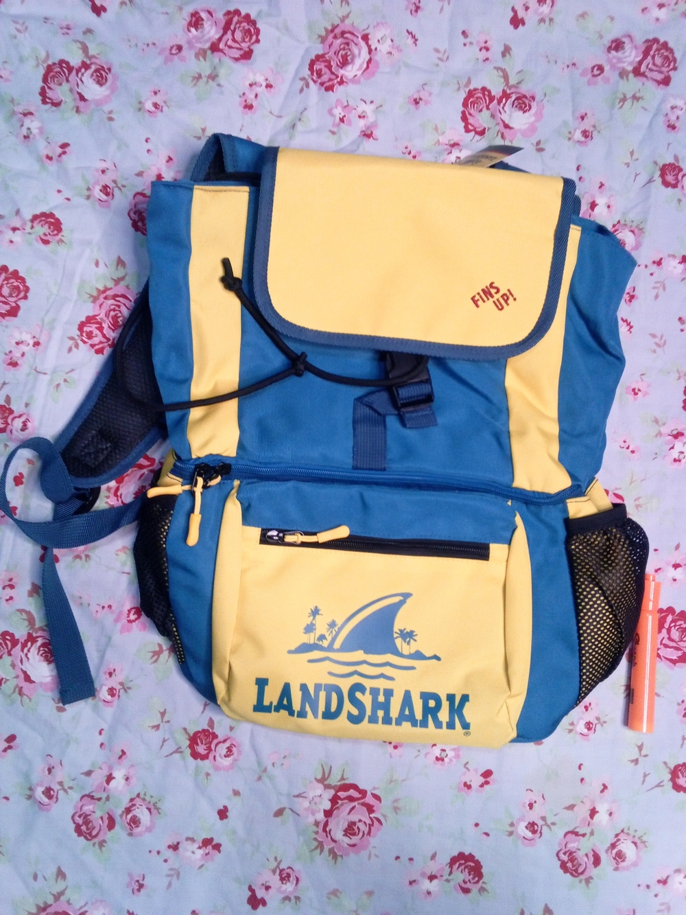 blue and yellow Landshark Lager cooler backpack with padded shoulder straps